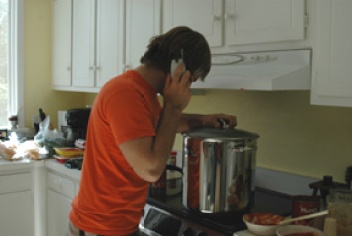 On the phone but still tending to the sauce, very important!