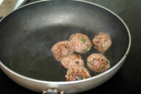 Browning the meatballs.