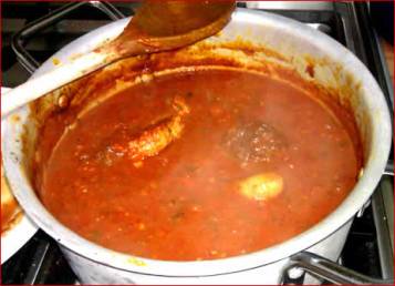 A pot of pasta sauce and meatballs